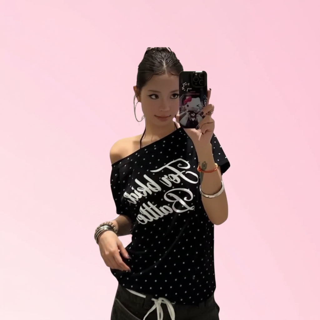 Woman wearing black polka dot graphic T-shirt