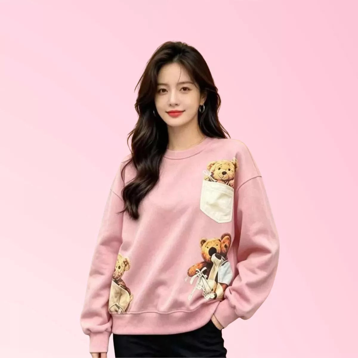 Women’s pink teddy bear graphic sweatshirt with pocket detail